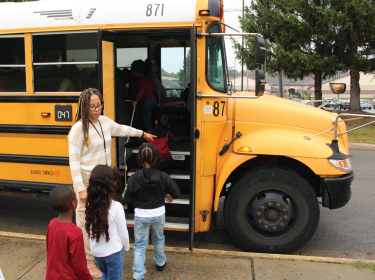 Students walking onto a bus